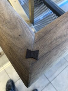 Wood corner joint with bowtie inlay